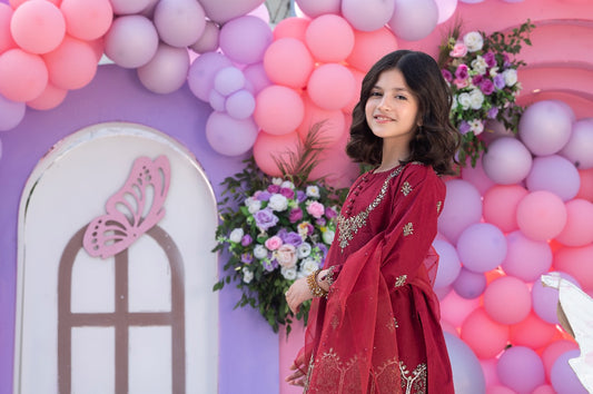 shirt adorned with sequin embroidery and delicate hanging pearls.